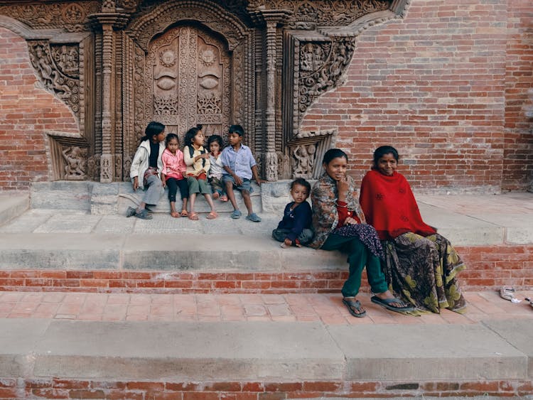 Woman With Kids At Steps Of Temple