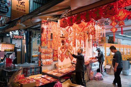 A bustling night market filled with colorful traditional decorations and busy shoppers.