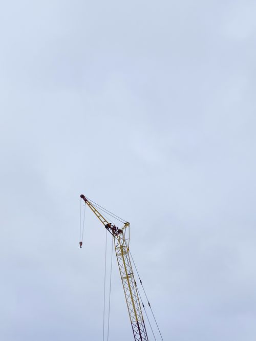 Free A tall crane reaches into the sky, silhouetted against cloud cover in Kazakhstan. Stock Photo