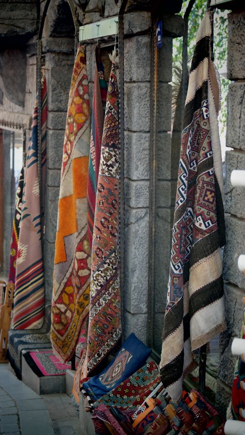 Free Vibrant handmade textiles on display at an outdoor bazaar with intricate patterns. Stock Photo