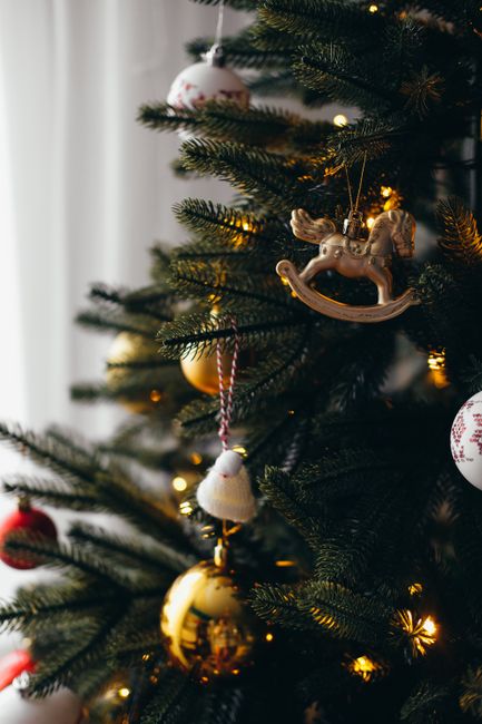Festive Christmas tree adorned with ornaments and warm lights.