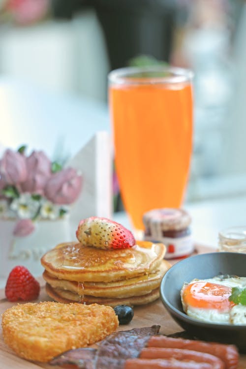 Free Pancakes and Other Breakfast Food and a Glass of Juice Stock Photo
