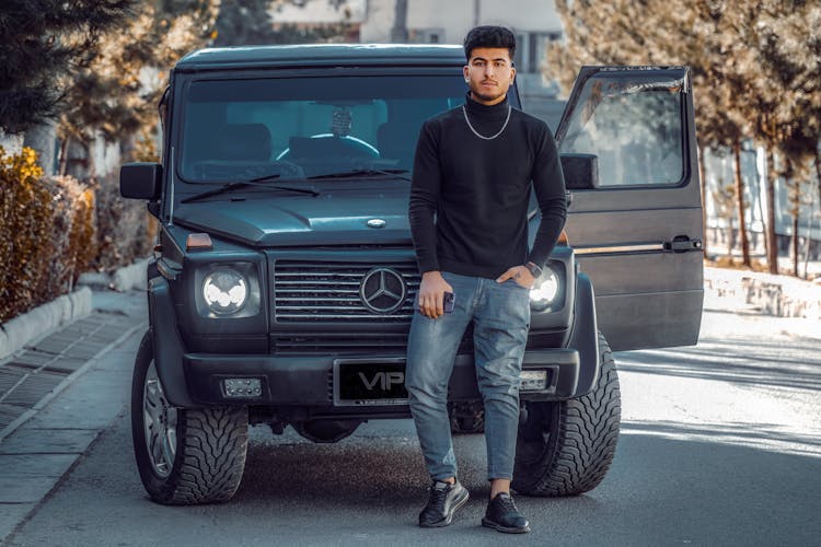 A Man Posing On The SUV