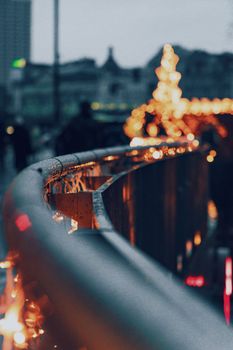 A captivating view of illuminated street handrails in Warsaw during a festive winter evening.