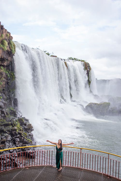 Woman in Gown Posing near Waterfall
