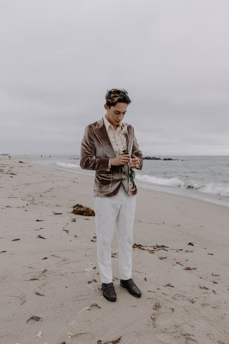 Man Standing On A Beach In A Suit