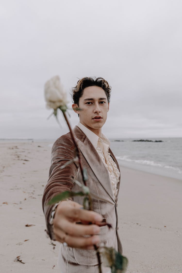 Man Holding Flower On Beach