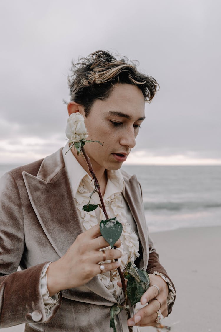 Man In Suit Holding Flower