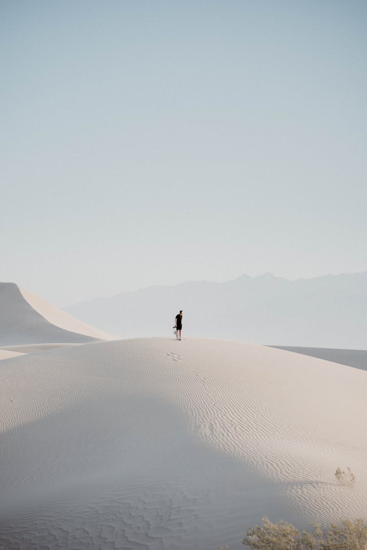 Man On Dune On Desert