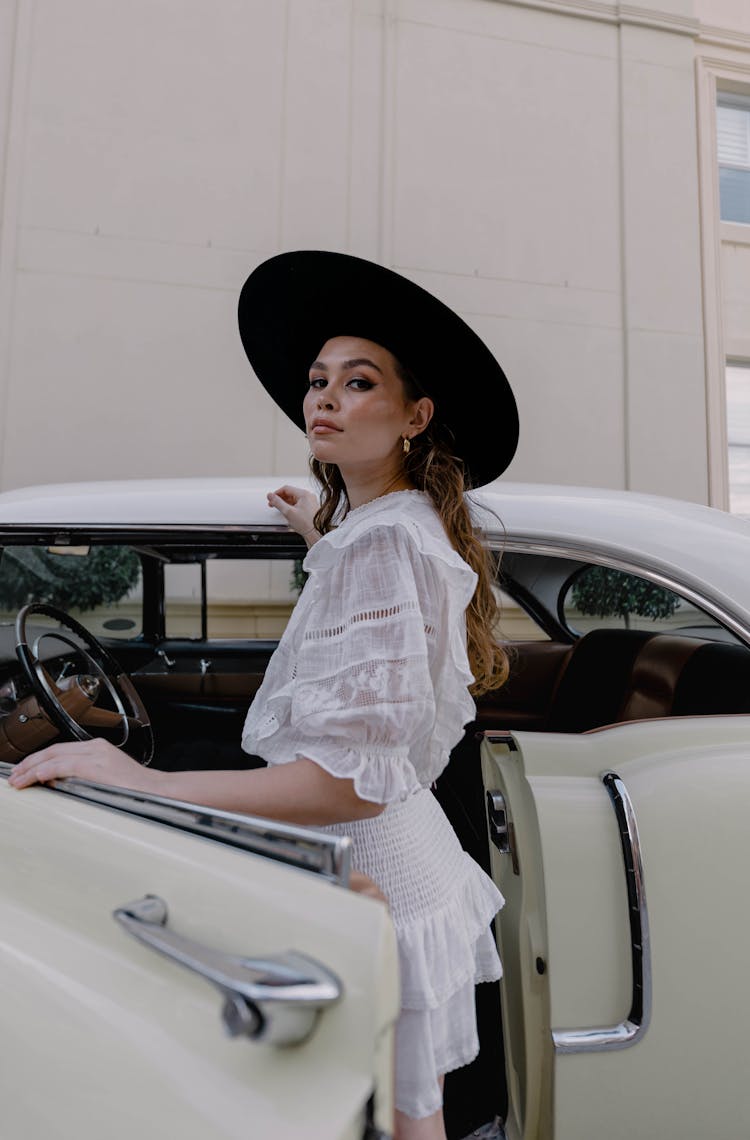 Woman In Hat Posing By Vintage Car