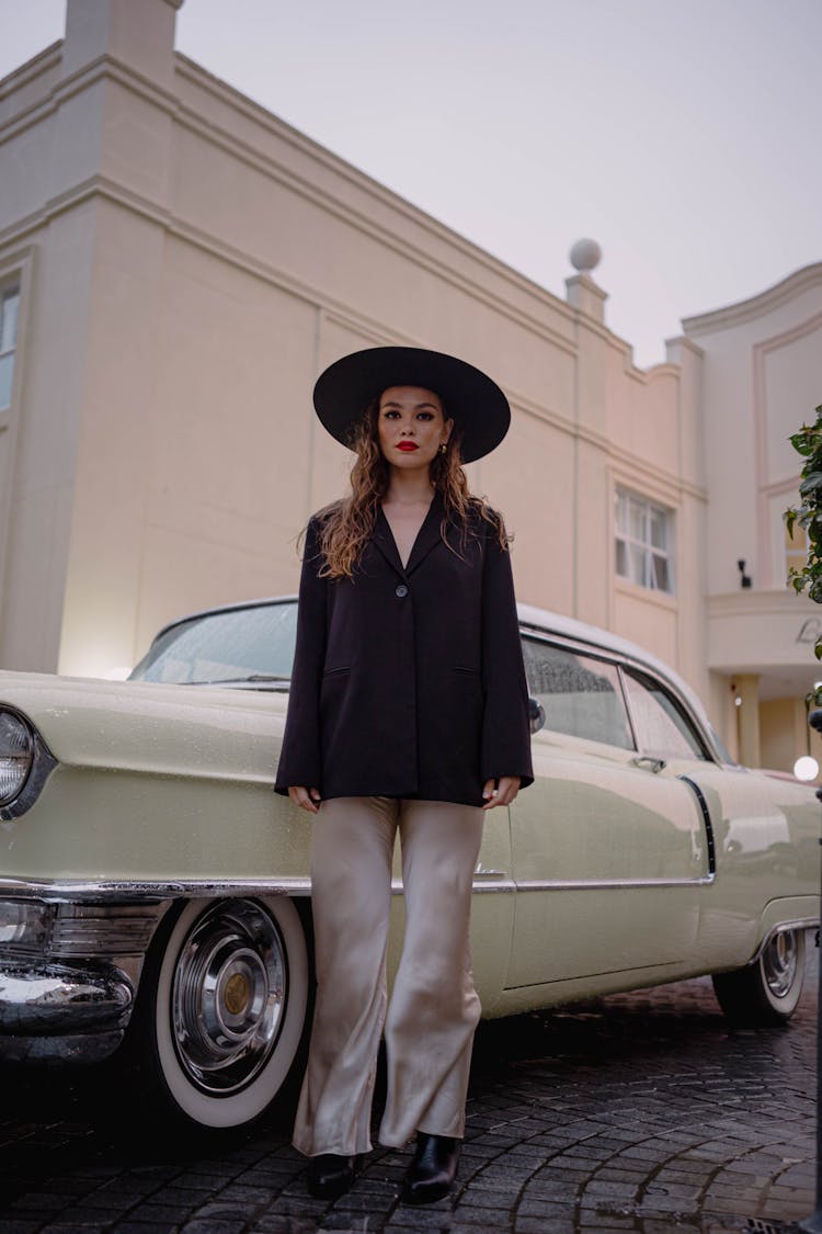 Woman In Hat Posing By Car