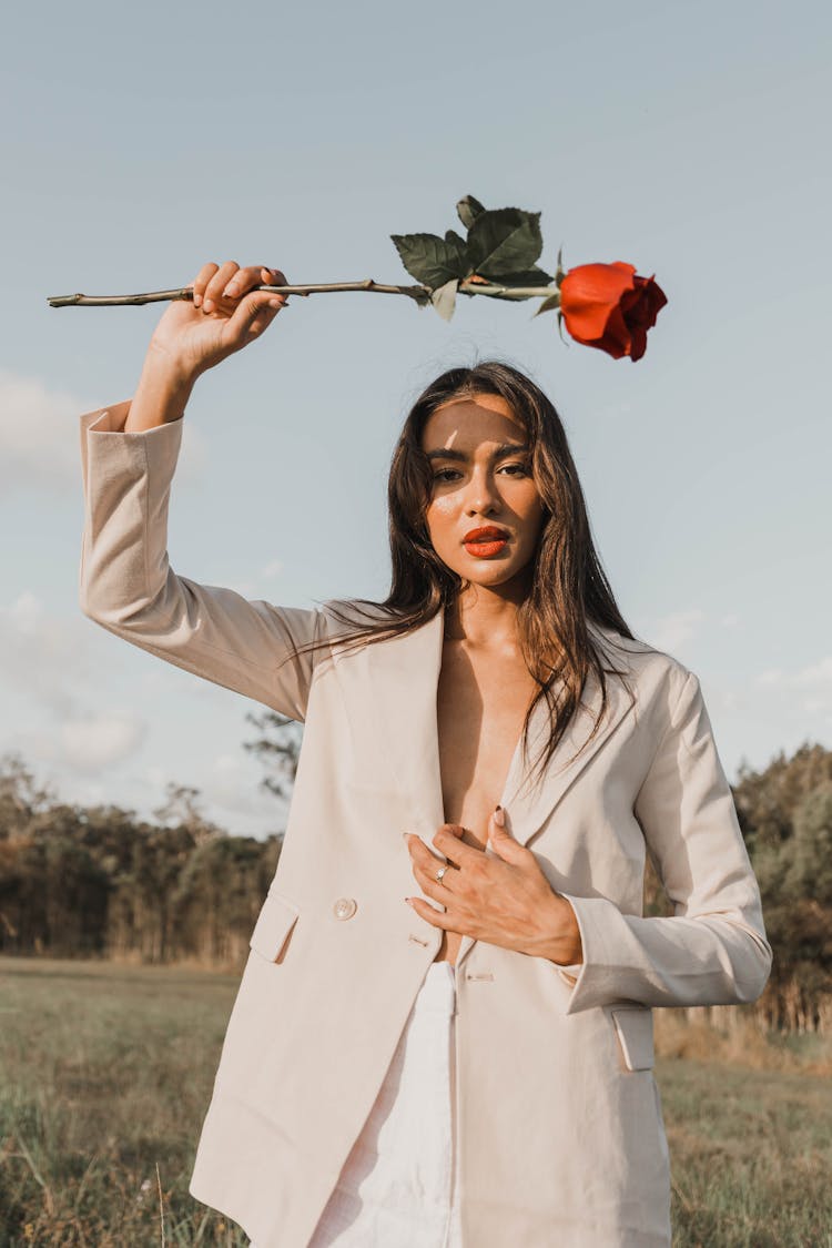 Portrait Of Woman In Suit With Flower