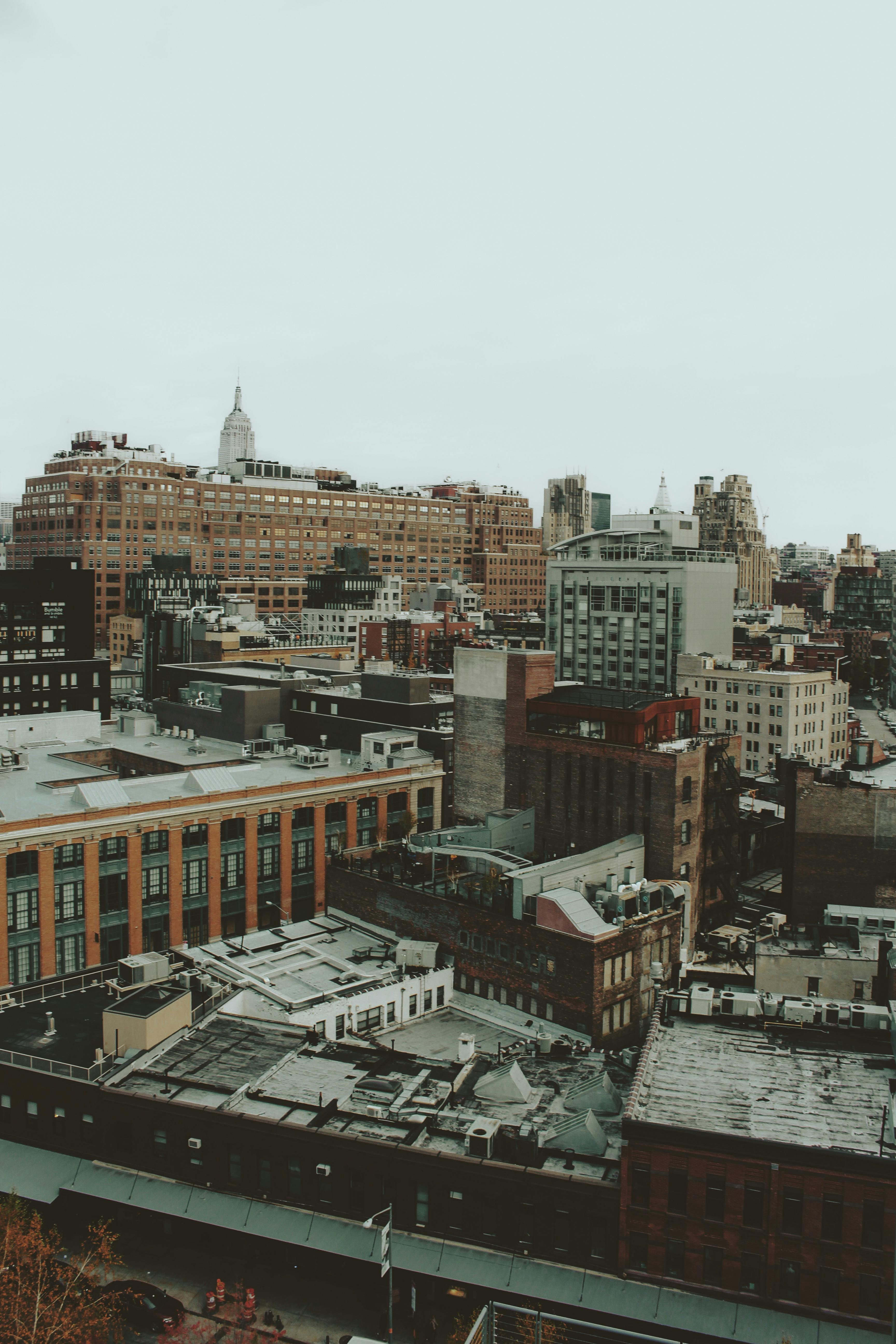 Aerial shot of a bustling city showcasing diverse architecture and iconic skyscrapers.