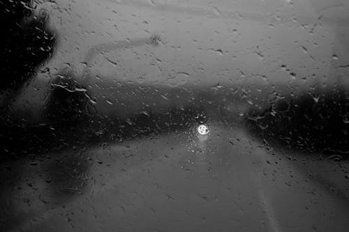 View on Road through Window in Raindrops