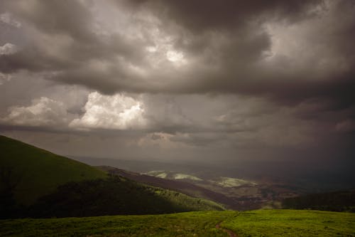 Dark Clouds above Hills in Countryside