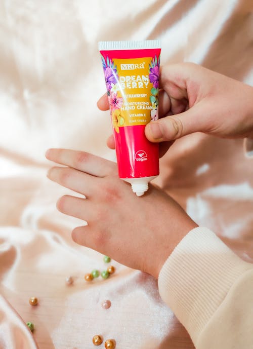 A Person Using a Hand Moisturizing Cream