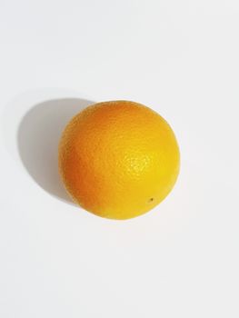 High-quality image of a single orange with shadow on a white background, perfect for design uses.