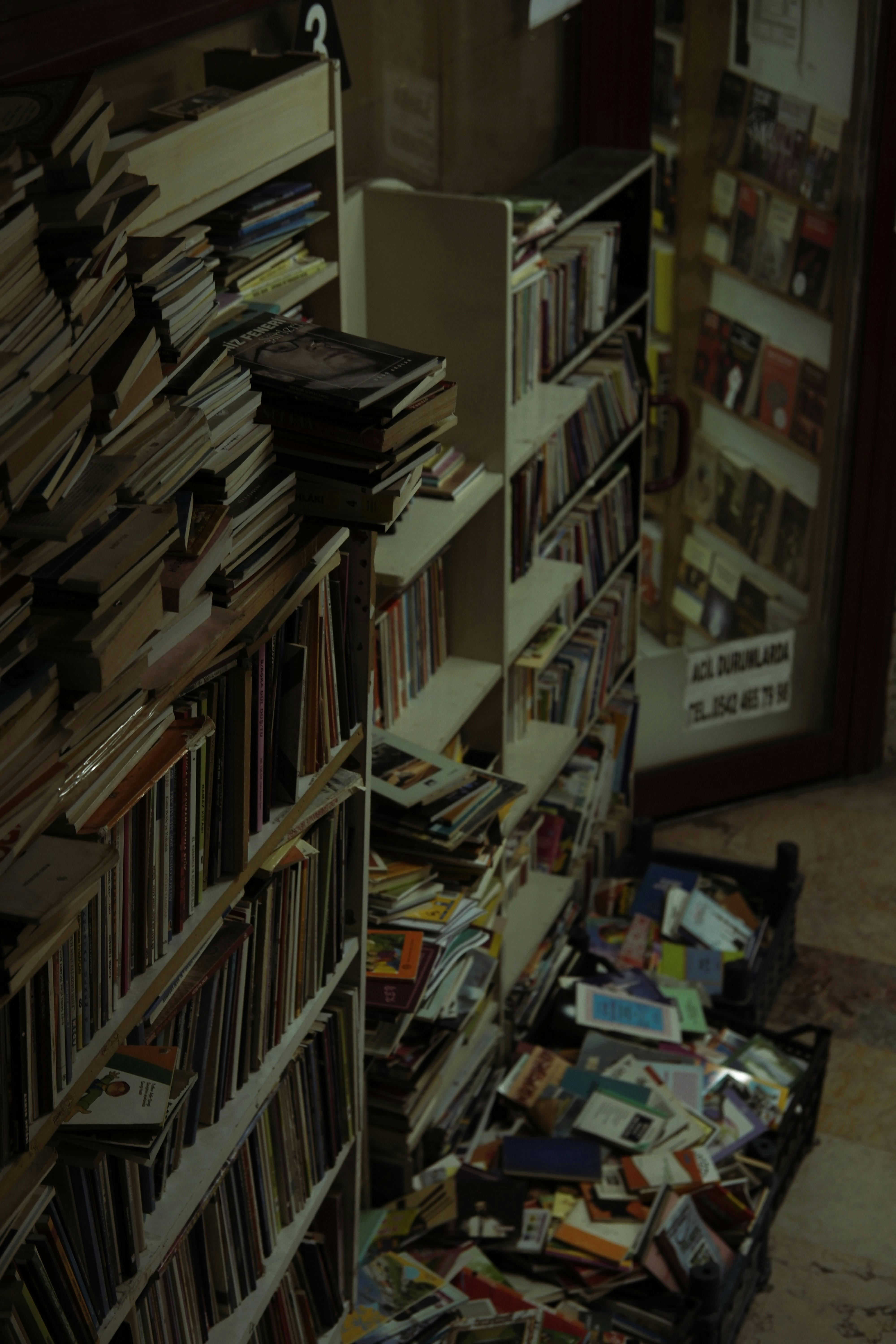 Discover a quaint, vintage bookstore filled with stacked, used books in a cozy atmosphere.