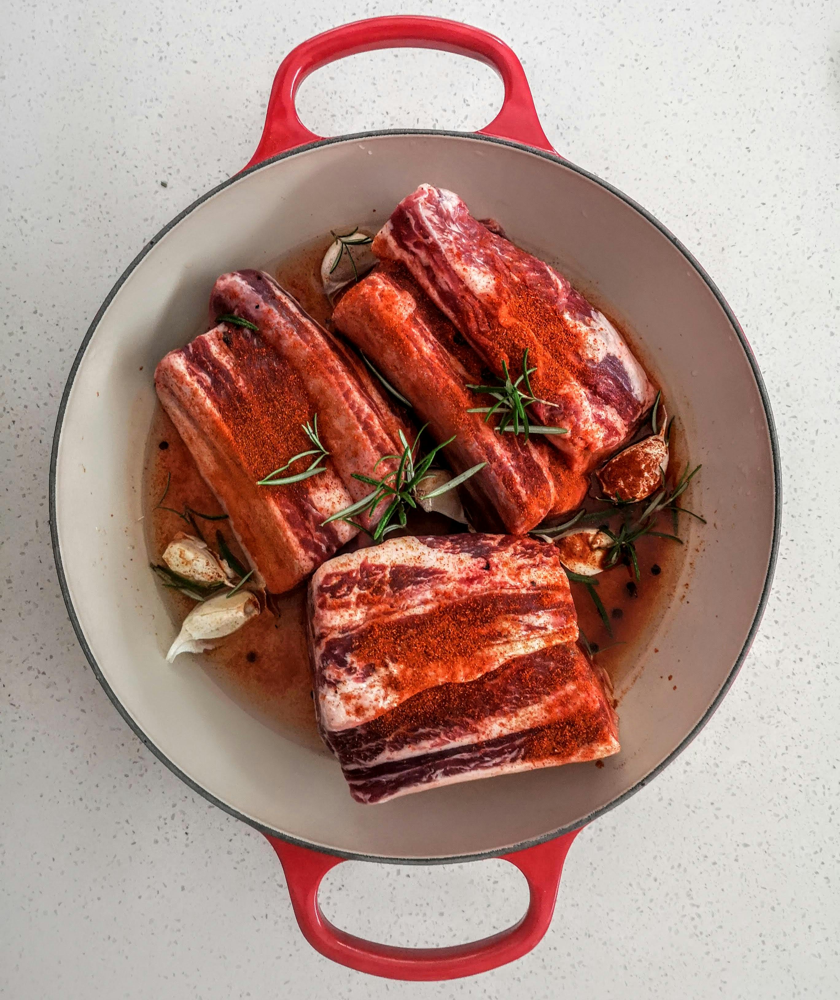Chef preparing BBQ ribs in a kitchen setting