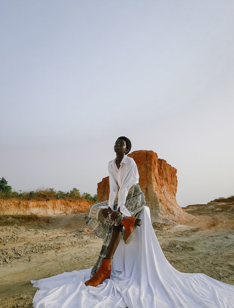 Woman Posing On Rocky Formation Landscape