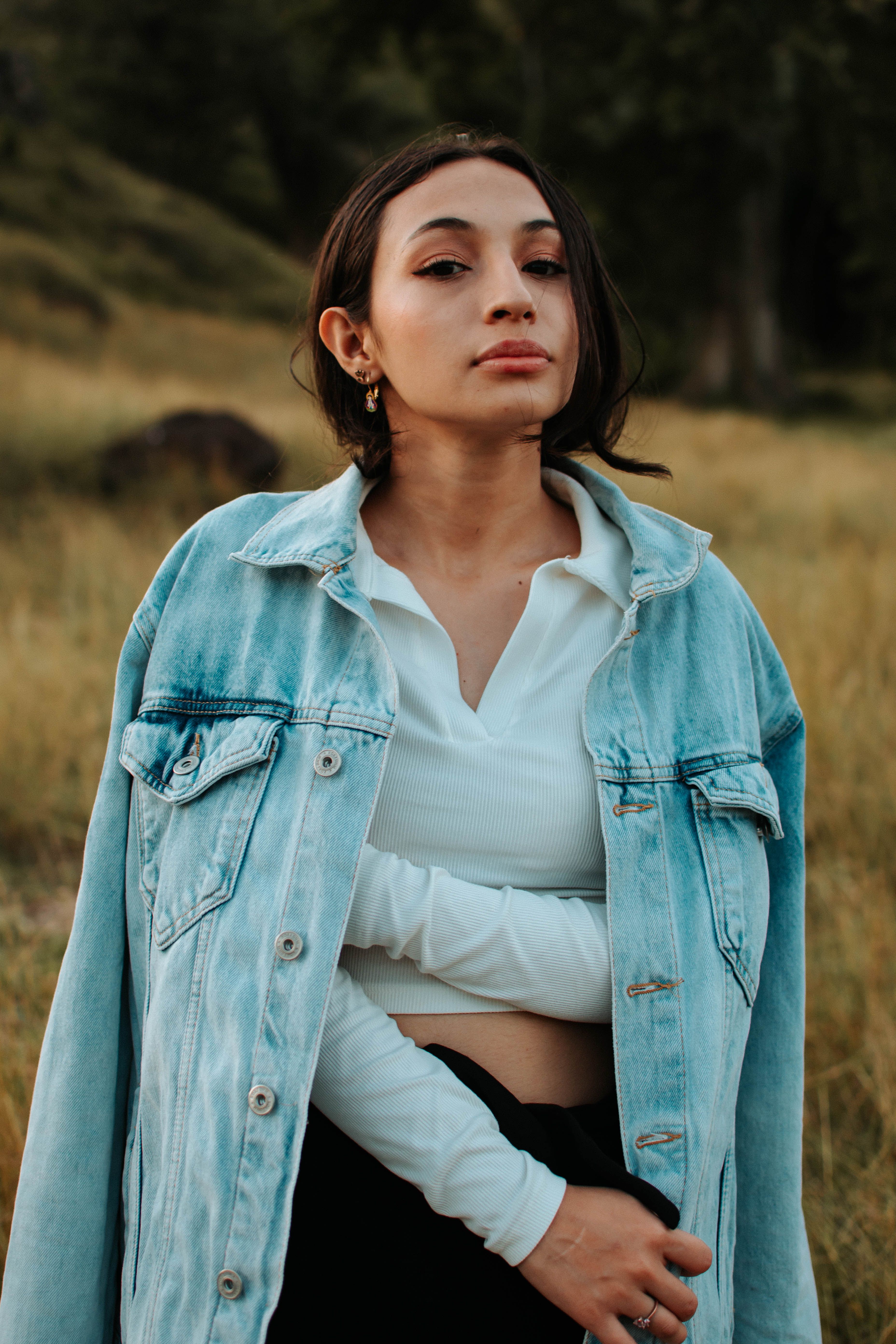 Woman in Blue Denim Jacket Standing on Dirt Road · Free Stock Photo