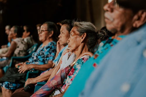 Elderly People Sitting in Line