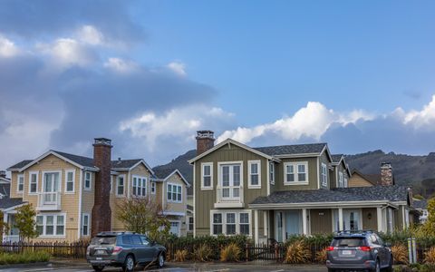Suburban homes with multiple cars parked along the street