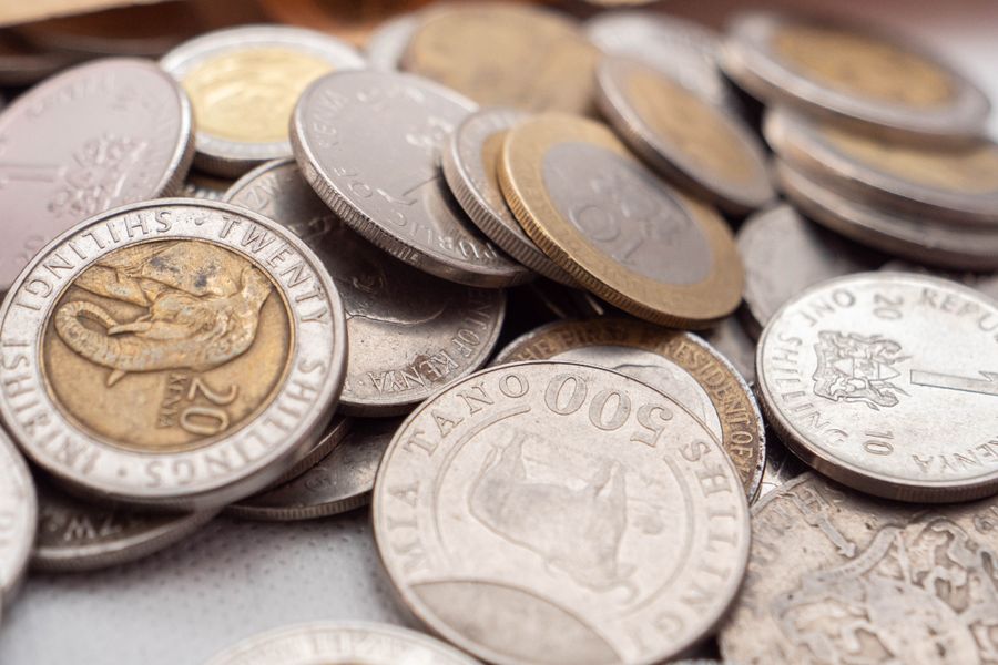 A detailed close-up image showcasing various Kenyan shilling coins, emphasizing their textures and inscriptions.