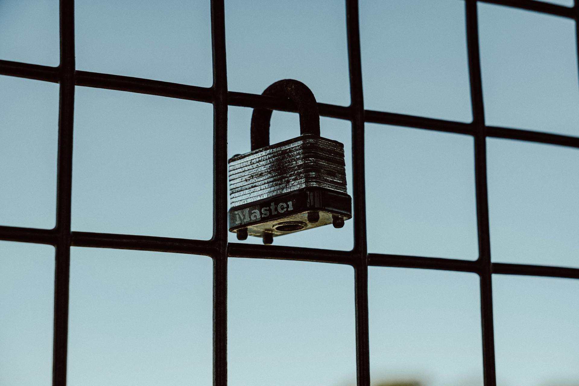 A close-up of a padlock securing a wire fence, symbolizing protection and safety.