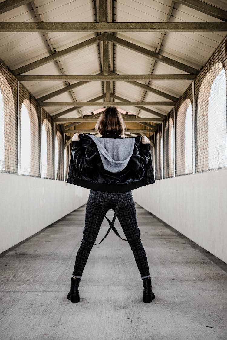 Woman In Jacket Posing In Tunnel