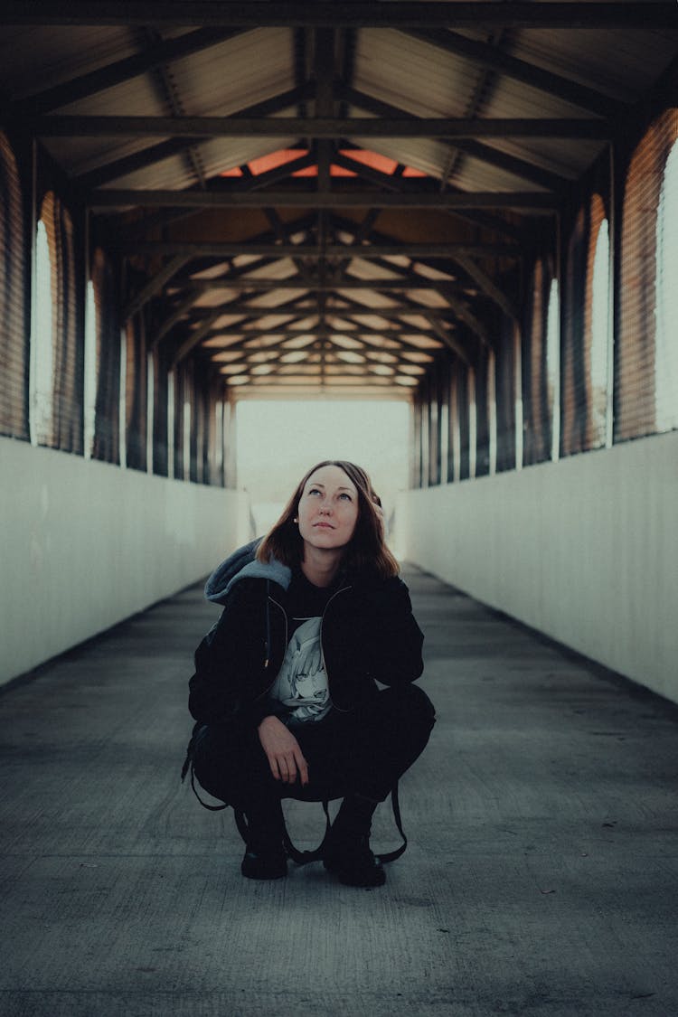 Woman Crouching In A Tunnel 