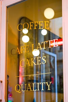 Close-up of a glass door with cafe menu reflection in Istanbul, displaying offerings like coffee and cakes.