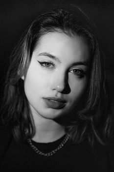 Striking black and white portrait showcasing a young woman's elegance.