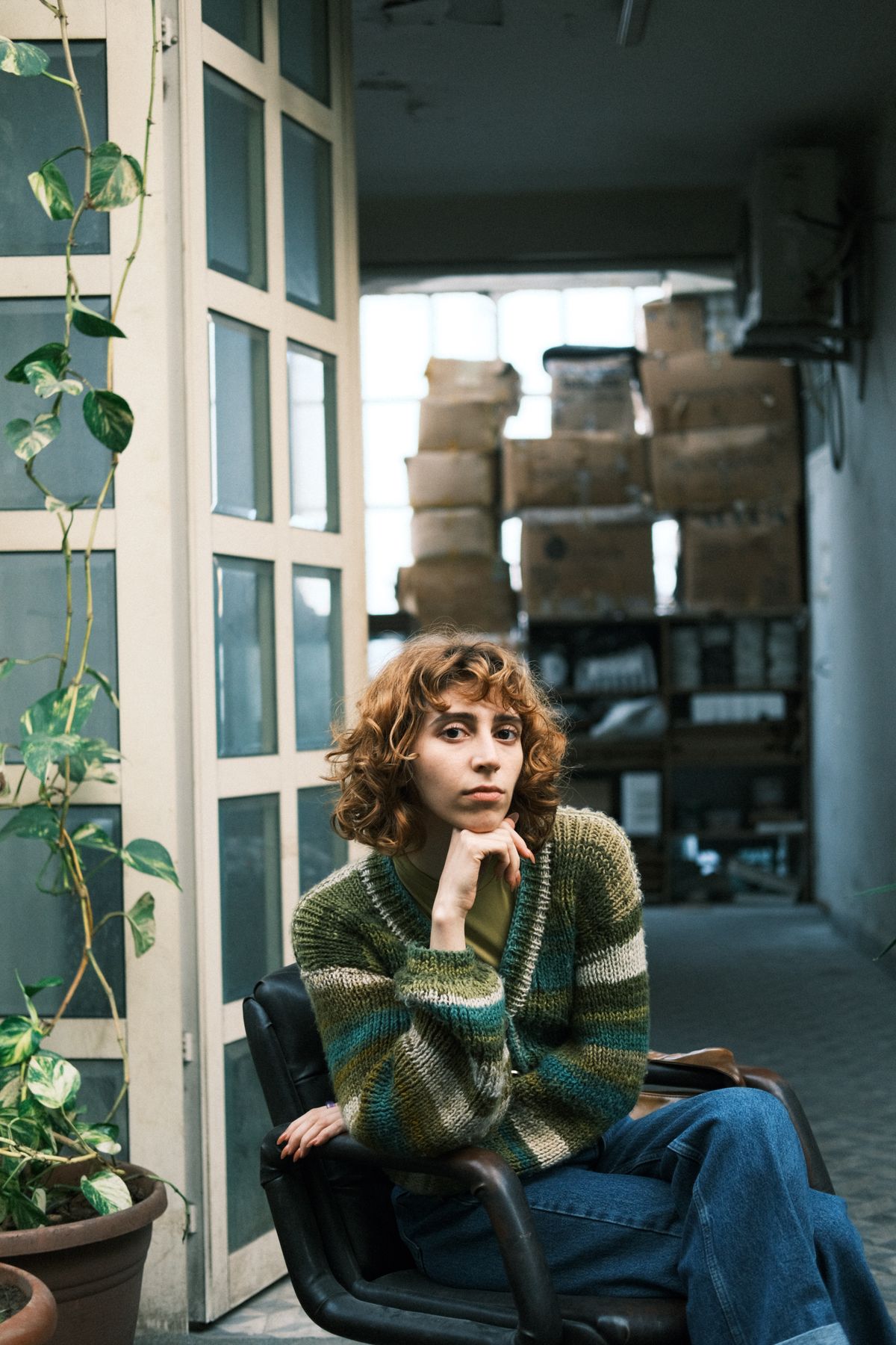 Woman styled in a cozy knit cardigan layer with jeans