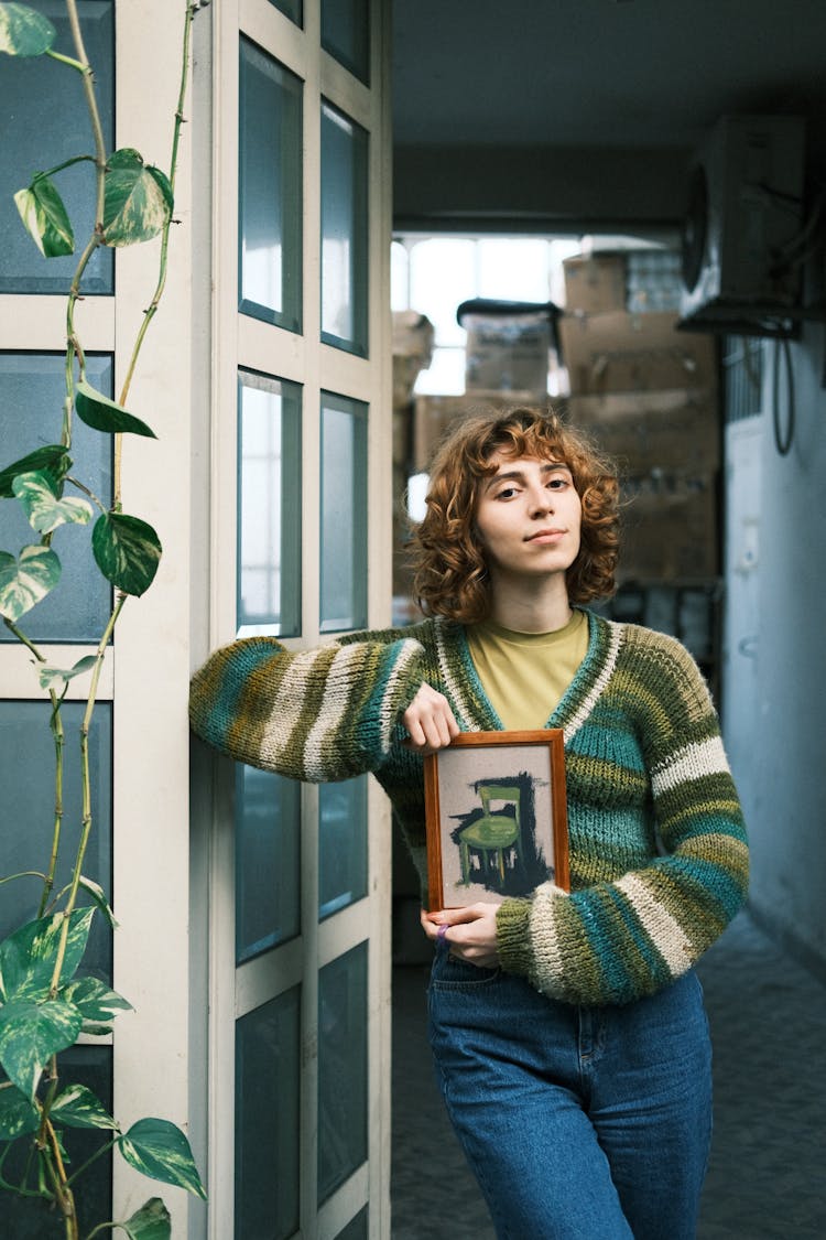 Woman Standing With Framed Picture