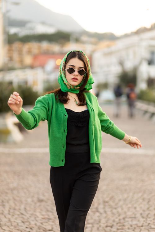 Fashionable woman in green outfit with sunglasses