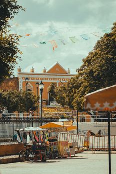 Vibrant street scene in Mexico with festive banners and classic architecture.