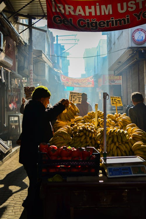 Man Selling Bananas at a Market 