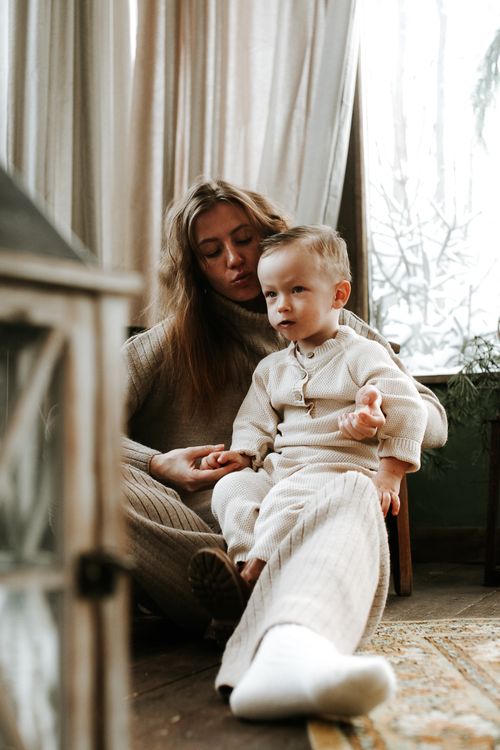 Free A serene moment of a mother and her son bonding indoors with natural light. Stock Photo