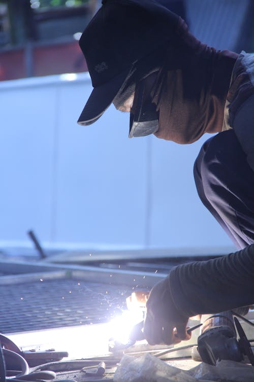 Man Using Welder in Factory