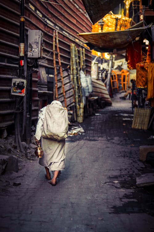 Elderly Woman in Narrow Street