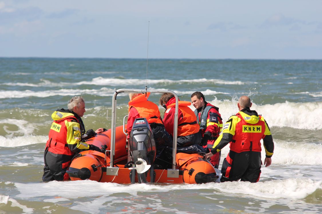 A Group of Lifeguards Standing in the Water with a Rescue Craft · Free ...