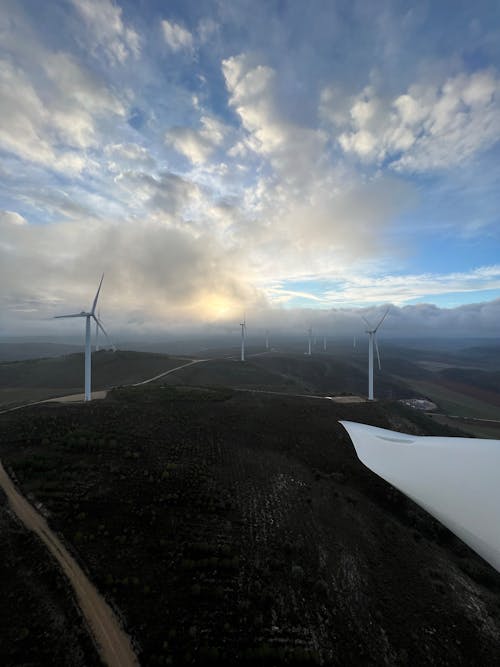 Wind Turbines Under Cloudy Sky