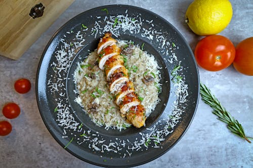 Free A plate of chicken and rice with tomatoes and herbs Stock Photo