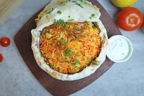 Free Vibrant Indian biryani with colorful spices served in a bowl, garnished with herbs. Stock Photo