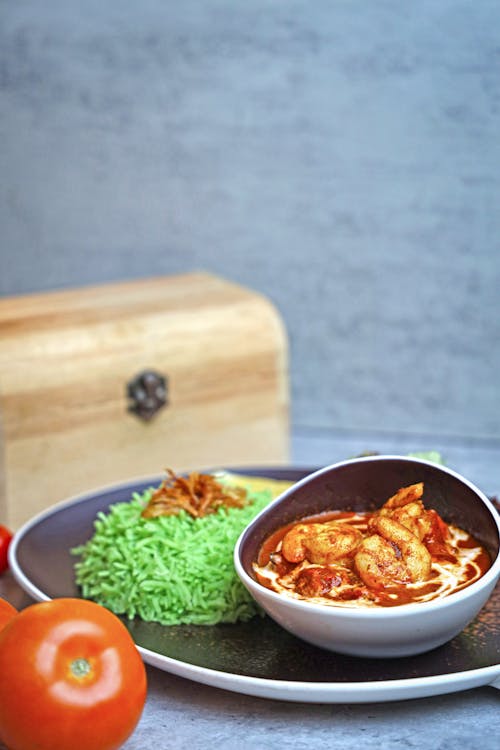 Green Rice and Shrimp with Sauce on Ceramic Plate and Bowl