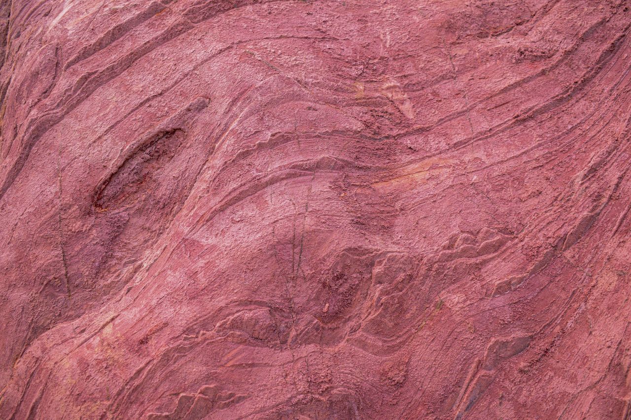 close up of red sandstone showing intricate natural patterns and textu