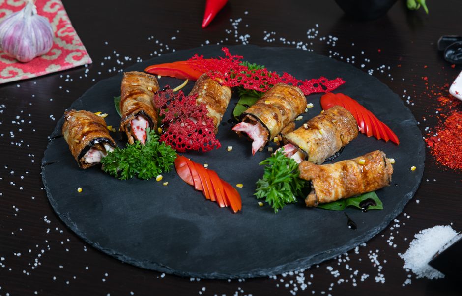 Photo by Collab Media on Pexels Exquisite sushi rolls with fresh vegetables elegantly presented on a dark platter. - Photo by Collab Media on Pexels