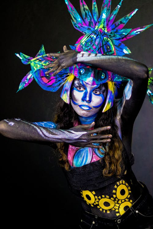 A woman with body paint and a flower headdress