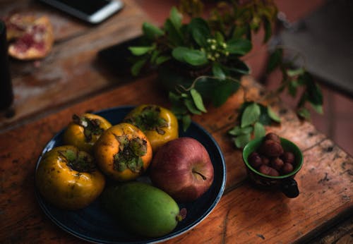 Free A Bowl with Fruit on a Wooden Table  Stock Photo